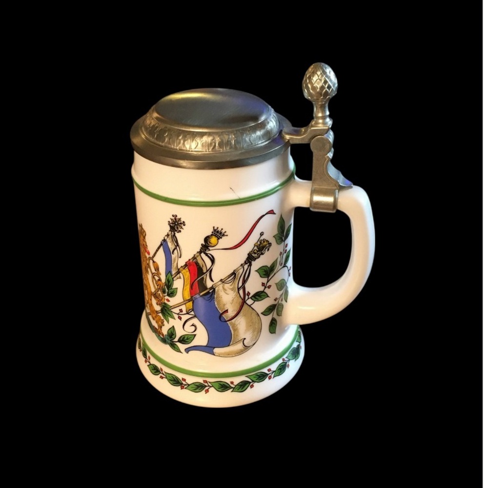 German beer stein with medieval flags and a flip up pewter kid.
